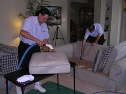 man cleaning couch